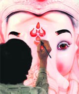 An artist works on an idol of Lord Ganesh at a workshop in Bangalore. 