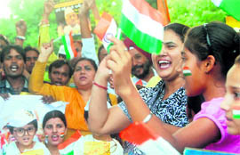 Supporters of Anna Hazare enjoy at the Sector-7 roundabout in Chandigarh on Sunday. 