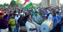 Annas supporters gather at the India Gate to mark their victory in New Delhi on Sunday.