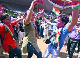 Anti-corruption campaigners break into a jig to express their happiness at the Ramlila Ground in New Delhi on Sunday.