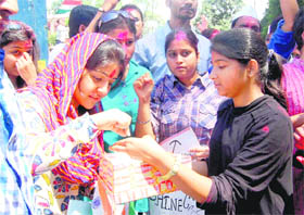 Anna Hazares supporters distribute sweets at the Gandhi Park in Dehradun on Sunday.