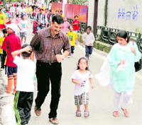 A couple with their child take part in the Monsoon Marathon in Nainital on Sunday
