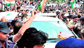 Supporters gather around the car of Anna Hazare as it enters the Medicity hospital in Gurgaon on Sunday.