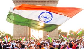 Anna Hazare fans celebrate at the India Gate on Sunday evening.