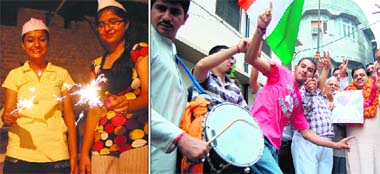 Activists of the Shaheed Bhagat Singh Brigade celebrate in Amritsar after Anna Hazare ended his fast on Sunday. (Right) Girls mark the occasion with fireworks in Jalandhar