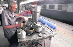 A vendor prepares tea at a stall at the Ludhiana railway station.