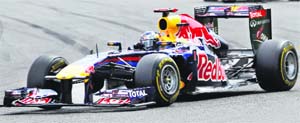 Red Bull driver Sebastian Vettel drives and celebrates in the parc ferme (top) during the Belgian Grand Prix in Spa-Francorchamps on Sunday. 