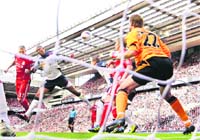 Liverpool's Martin Skrtel (L) scores against Bolton Wanderers during their English Premier League soccer match at Anfield in Liverpool on Saturday