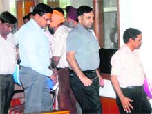MC officials stage a walkout from the MC General House on Monday. 