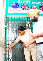 Policemen seal Globus Consulting Group Private Limited at Sector 20 in Chandigarh on Monday. 