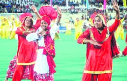 Fencers play a match ;students of GMSSS-16 dance during the National Sports Day celebrations at Hockey Stadium, Chandigarh, on Monday.