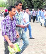 Not affected by the ongoing poll fever in city colleges, boys on their way to attend classes on Monday .