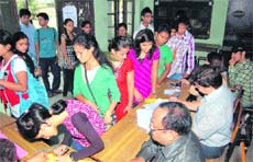 Students line up to vote in the students council elections at DBS PG College in Dehradun on Monday.