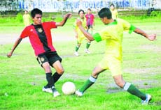 Two players vie for the ball in a match in the Lala Nemi Dass Memorial District Football League played at the Pavilion ground in Dehradun on Monday. 