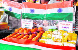 Corruption-free ladoos and Tiranga burfi at a sweet shop near Bhagat Singh Chowk in Haridwar on Monday.