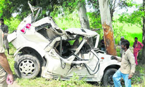The mangled remains of the vehicle that overturned and hit against a tree, killing two persons near Dariyapur in Fatehabad 