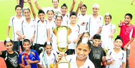 Players of the Surjit Hockey Academy hold the S.N. Vohra Hockey Trophy in Jalandhar on Monday.