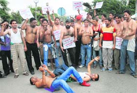 Cable TV operators stage a protest against Fastway company in Jalandhar on Monday