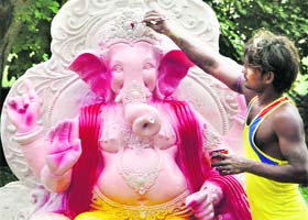 Artisans give finishing touches to an idol of Lord Ganesh ahead of Ganesh Chaturthi in Jalandhar on Monday