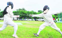 Fencing players in action on National Sports Day organised by the Department of Youth Services at the KK Hakku Hockey Stadium in Jammu