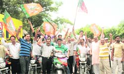 Activists of the BJP hold a scooter rally against corruption in Jammu