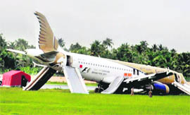 A Gulf Air passenger plane lies on the ground after it skidded off the runway at Kochi airport on Monday.