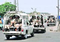 CLOSE WATCH: Pakistan paramilitary soldiers during a house-to-house search operation against criminal gangs and the extortion mafia in Karachi