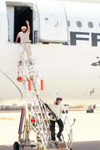 PRIZED BOOTY: A Libyan rebel flashes the victory sign as he steps out of Muammar Gaddafis Afriqiyah One Airbus A340 plane at Tripoli airport on Monday