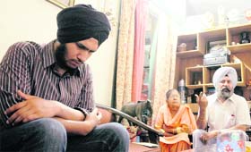 Amandeep Singh (left), one of the survivors in the accident in which his four friends died, at his residence in Sector 24, Chandigarh, on Tuesday.