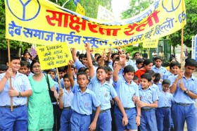 Schoolchildren hold the Sakshrata rally to spread the awareness about education in South Delhi on Tuesday.