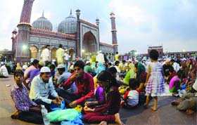 Muslims break fast (roja) on the eve of Id at the Jama Masjid in Old Delhi on Tuesday. 