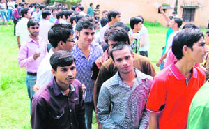 Students await their turn to vote in the students council elections of DAV PG College in Dehradun 