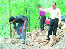 MC employees demolish illegal structures on MPG College land in Mussoorie.