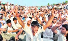 Maruti workers shout slogans outside the Manesar plant in Gurgaon on Tuesday. 