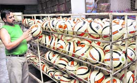 A worker at Freewill Sports checks a Simbolo football. These footballs will be used in the Argentina-Venezuela friendly match, featuring soccer star Lionel Messi, on September 2 at Salt Lake Stadium in Kolkata