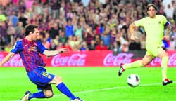 Barcelona's Lionel Messi (L) scores during the Spanish League in Barcelona on Wednesday. Barcelona crushed Villarreal 5-0 .  AFP 