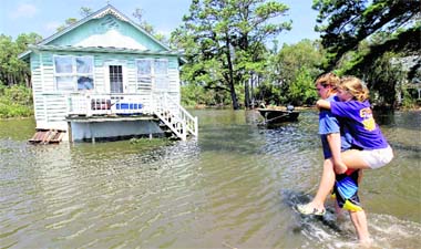 Residents make their way into their flooded home at Stumpy Point in North Carolina.