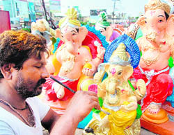 An artist gives final touches to an idol of Ganesha in Amritsar. 