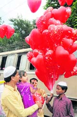 A man buys balloons for his daughter in Dehradun on Wednesday.