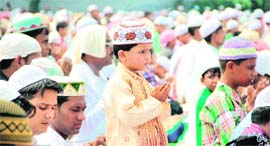 A tiny tot, along with elders, offers namaaz at the Eidgaah on Eid in Jalandhar
