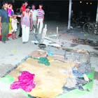 Stunned people watch the pavement where the labourers were sleeping when they were hit by a speeding car on Hambran road on Tuesday.