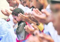 A girl offers prayers on the occasion of Eid-ul-zuha in Ludhiana on Wednesday.