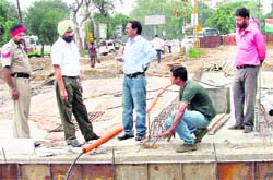 MC officiating commissioner Malwinder Singh Jaggi (second from left) inspects the construction of the underpass opposite the Mini Secretariat on Wednesday. 