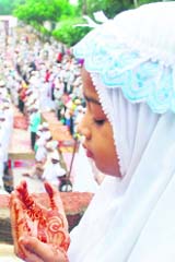 A young girl prays during the special Eid morning prayers at a mosque in Patiala.