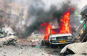 Flames rise from a car at the site of a bomb blast in Quetta on Wednesday