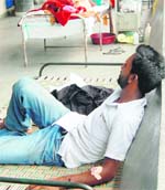 A patient at the orthopaedic ward of Guru Nanak Dev Hospital sit on his personal bed owning to a shortage of beds in the ward in Amritsar. 