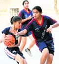 A player of the St Kabir team tries to snatch the ball from 
