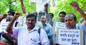 Activists of the AICCTU along with workers of Maruti company hold protest at Jantar Mantar in New Delhi on Thursday.