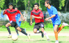 A match between Vijay Cantt (in blue) and Sunderwala Boys (in red) in the Lala Nemi Dass Memorial District Football League played at the Pavilion Ground in Dehradun 