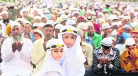 Children exchange greetings as elders offer prayers on Eid-ul-Fitr at a mosque in Gurgaon.